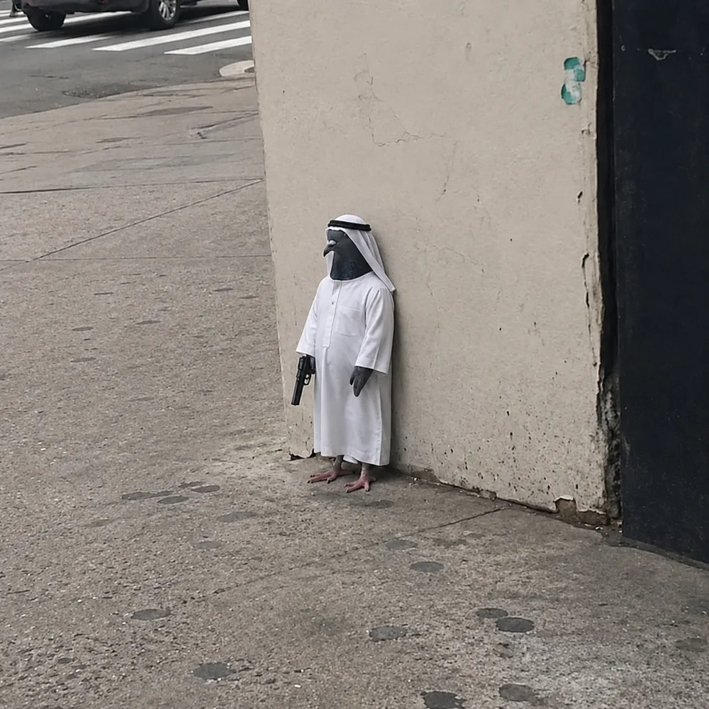 The pigeon leaning against the wall — white robe.